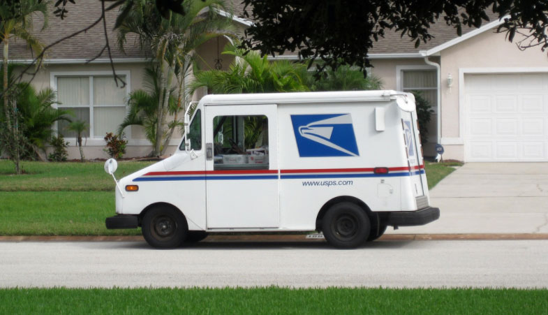 USPS van on the side walk deliver mail injection to homes